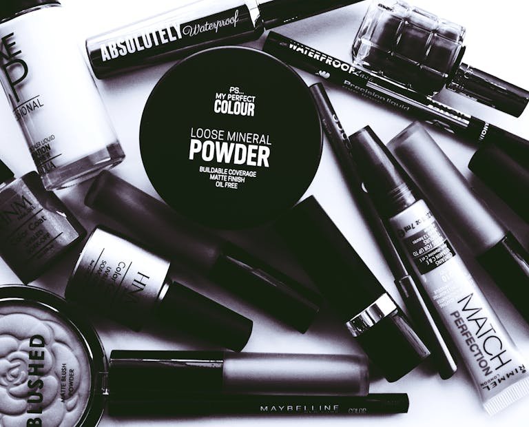 Elegant monochrome flatlay showcasing a collection of beauty products and cosmetics.