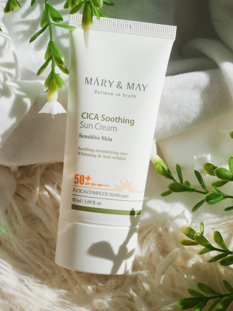 Organic sun cream amidst green foliage, perfect for sensitive skin protection.